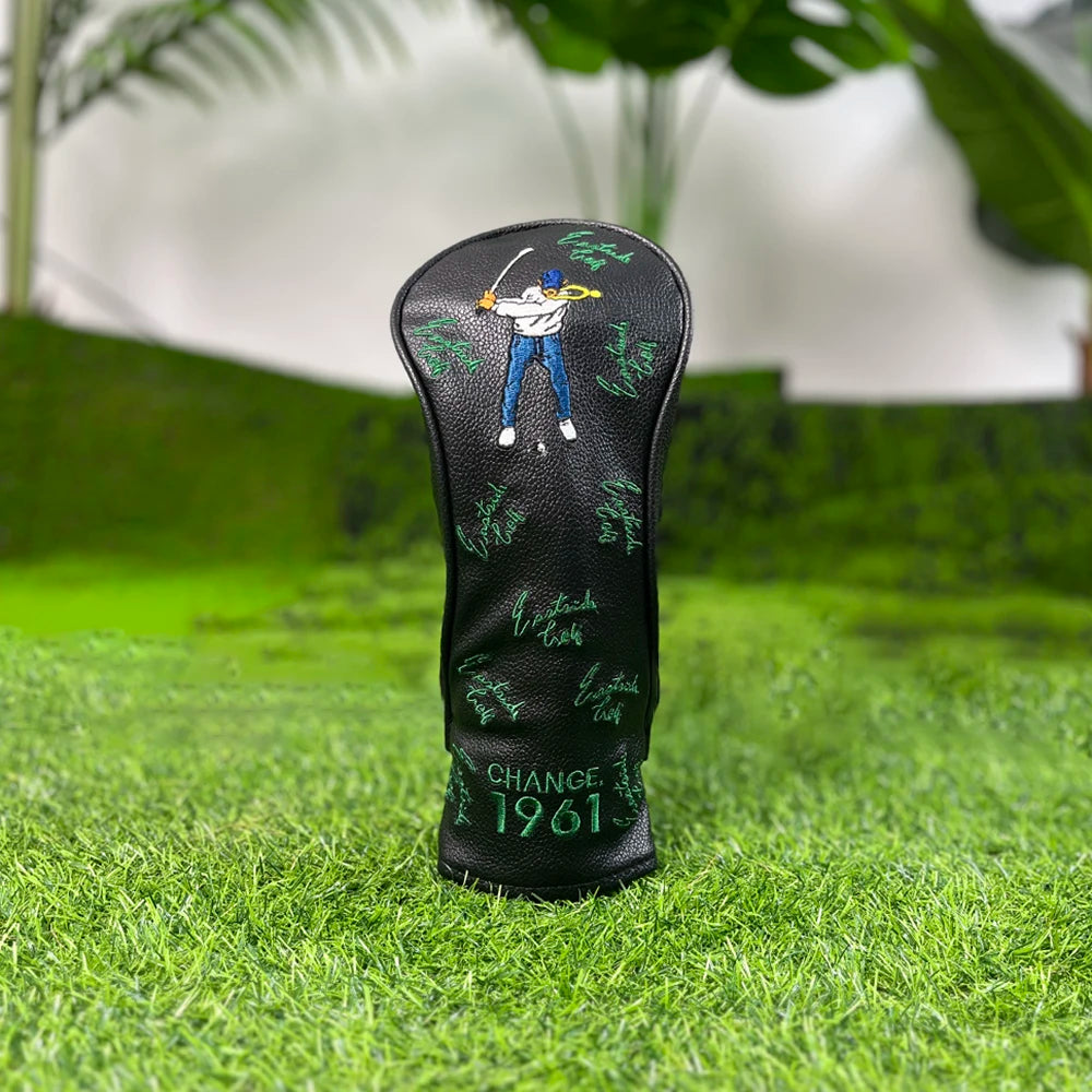 Black golf club head cover featuring a silhouette of a golfer and the text CHANGE 1961 placed on green grass.