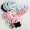 A collection of colorful microfiber skincare headbands and wristbands in pastel shades.