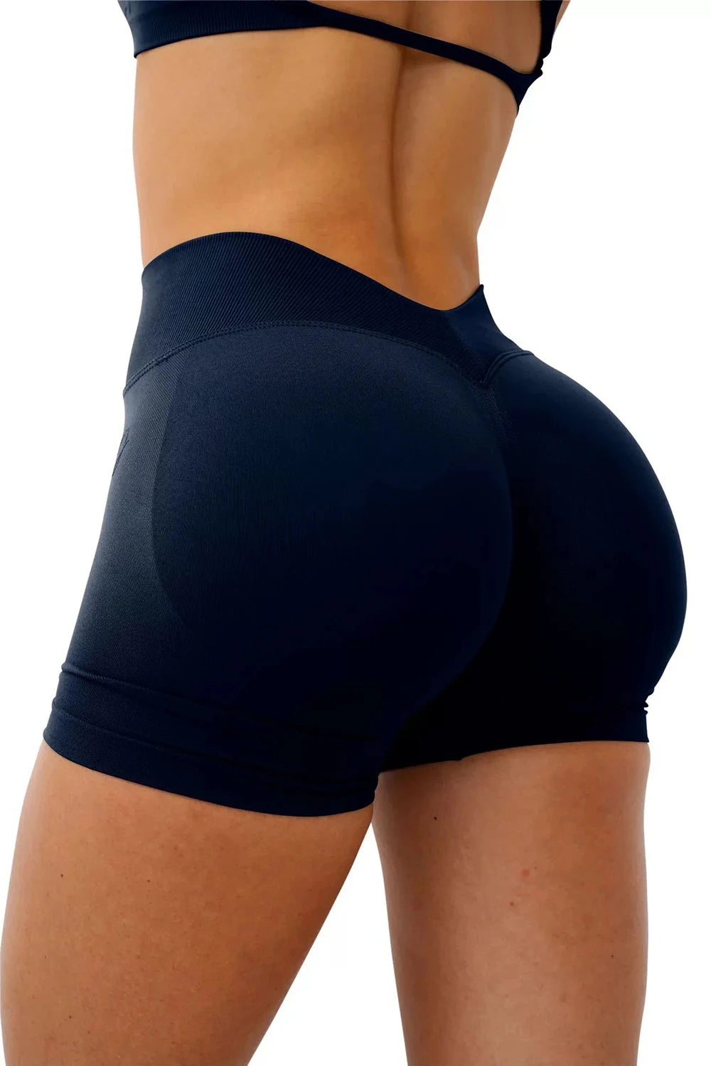 A woman wearing dark blue seamless yoga shorts for fitness and workout.