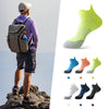 A person wearing running socks is shown alongside various colors and styles of breathable anti-blister running socks.