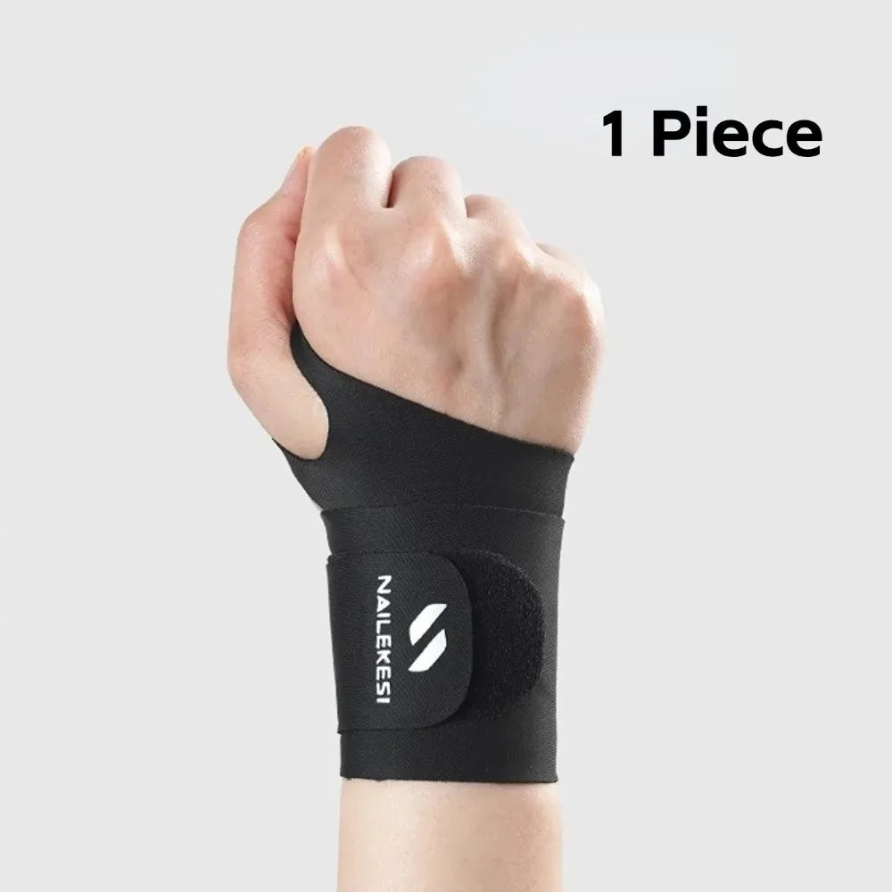 A black nailekesi wrist compression brace is shown on a person's hand and wrist.