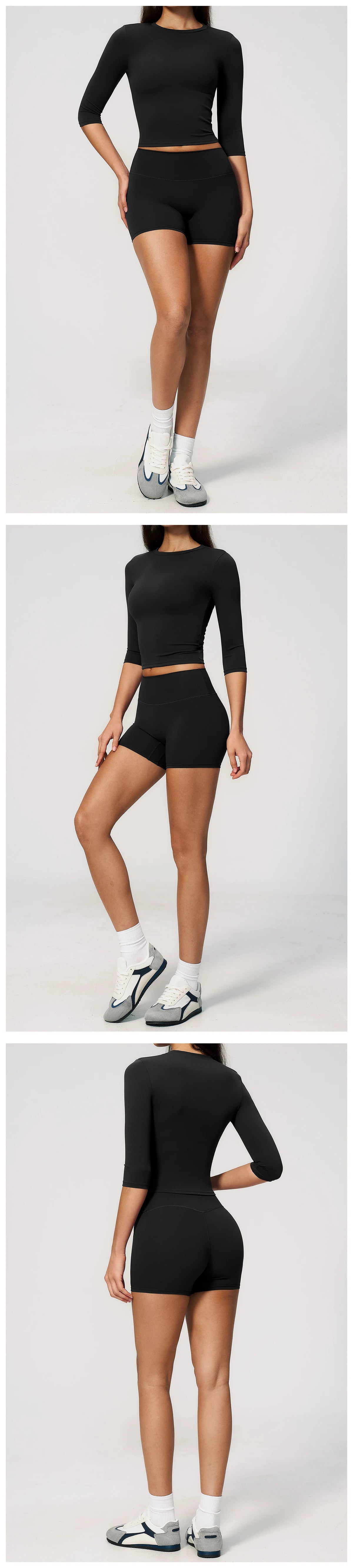 A woman models a black long-sleeved top and matching high-waisted shorts set of yoga and fitness leggings.