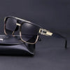 A pair of classic retro square sunglasses with gold accents resting on a black leather case.