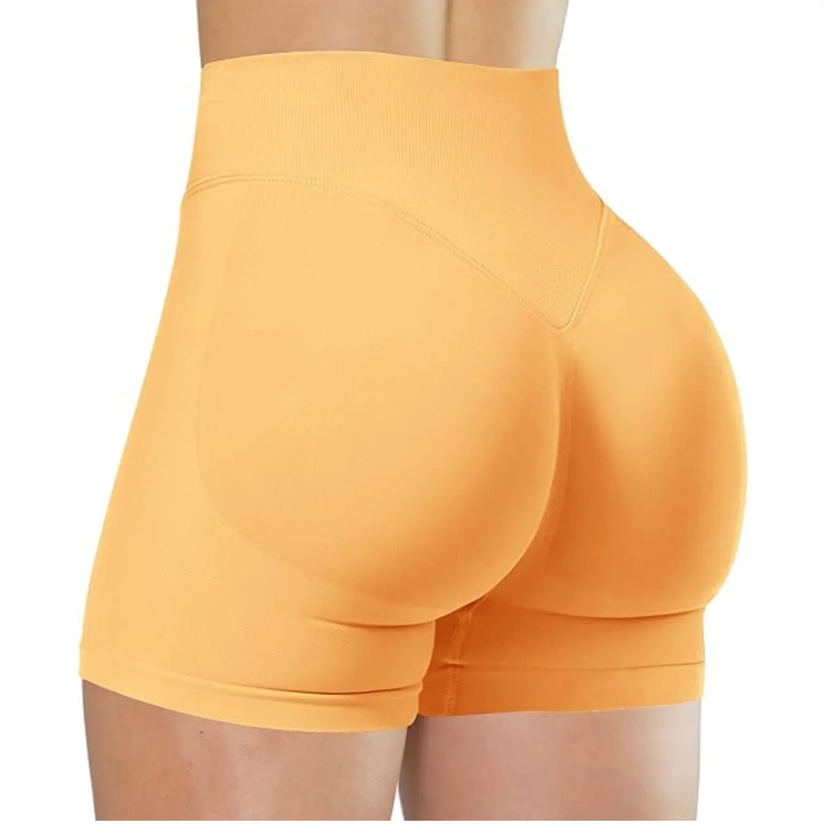A close-up of a woman wearing high-waisted orange yoga shorts.