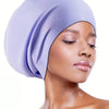 A model wearing a lavender silicone swim cap for long hair against a white background.