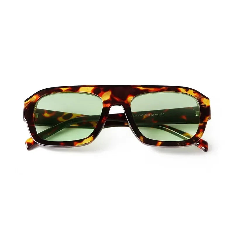 Vintage oversized square sunglasses with a tortoiseshell pattern frame and green tinted lenses.