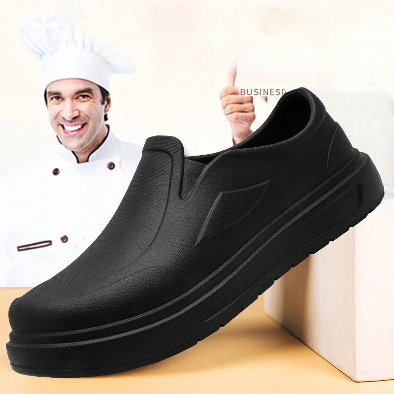 A black men's anti-slip oil-resistant kitchen clog is shown next to a chef and a white block.