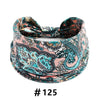 Boho print cotton headband featuring intricate teal, pink, and black floral patterns.