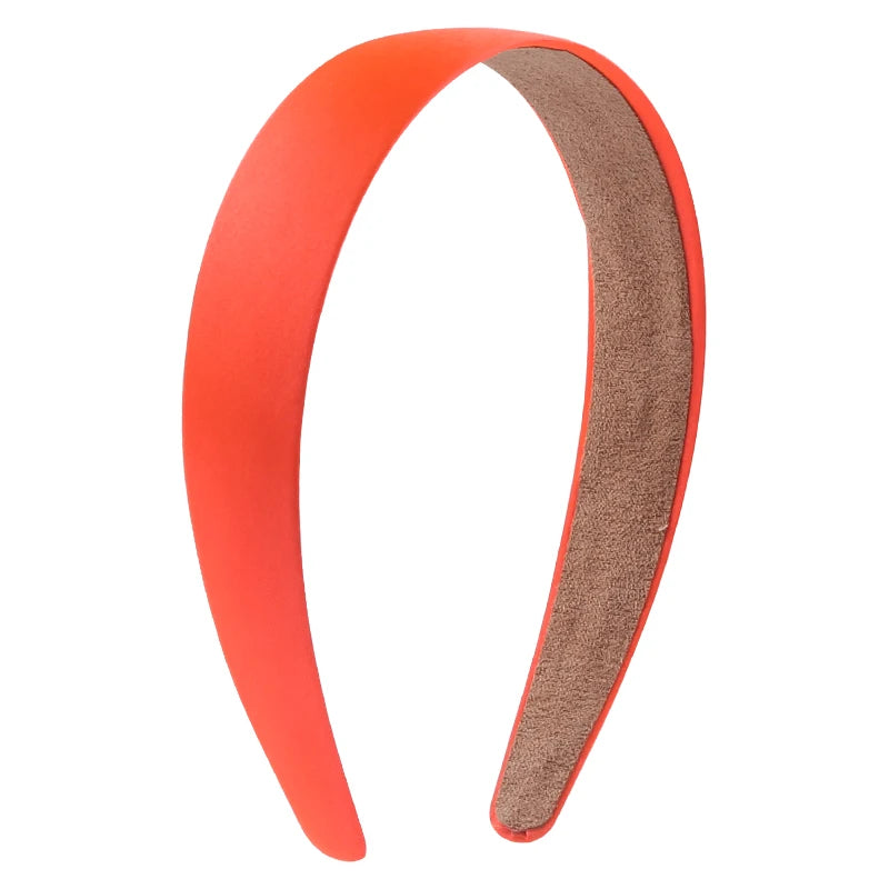 A pair of solid satin hair bands, one orange and one brown, shown against a white background.