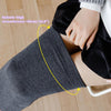 A close-up of gray thigh high leg warmers being worn on a leg, showing the fit around the thigh.
