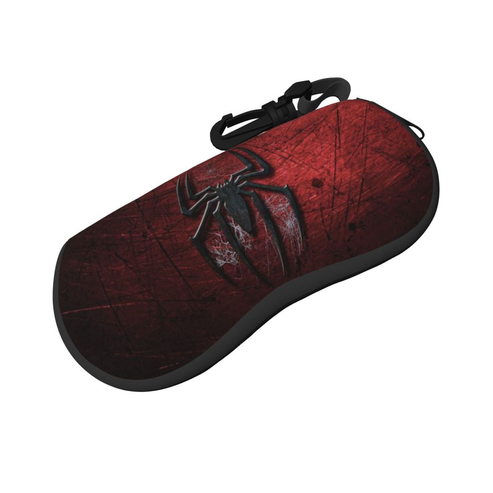 A dark red pouch with a black spider web design and a black strap.