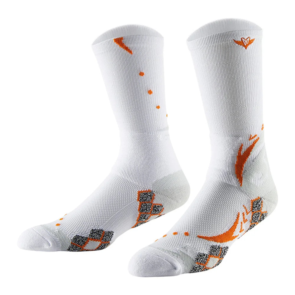 A pair of white athletic socks with orange detailing and a textured knit pattern.