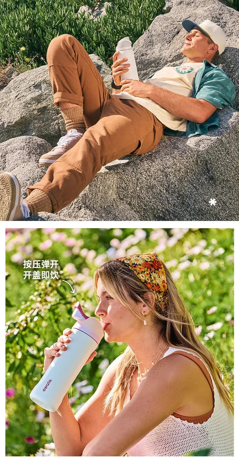 A woman holds an Owala insulated stainless steel tumbler with a straw lid outdoors.