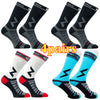 Four pairs of black and gray compression cycling socks shown from various angles