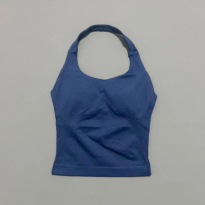 A navy blue seamless performance yoga and gym tank top displayed flat.