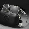 A pair of clear-framed square polarized photochromic sunglasses resting on a black pouch.