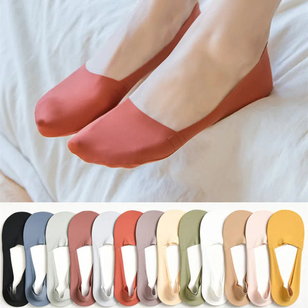 A row of various colored silicone anti-slip summer socks displayed on a white background.