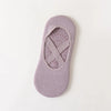 A pair of mauve non-slip yoga and gym socks with a silicone grip on the sole.