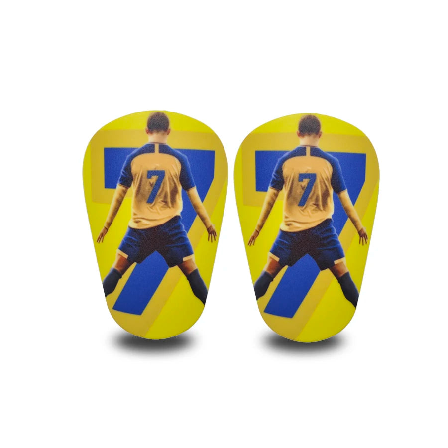 Dos jugadores con camisetas amarillas y azules de espinilleras de fútbol mini, de espaldas a la cámara.
