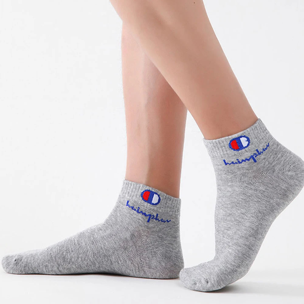 Gray ankle socks with a red and blue logo on the cuff