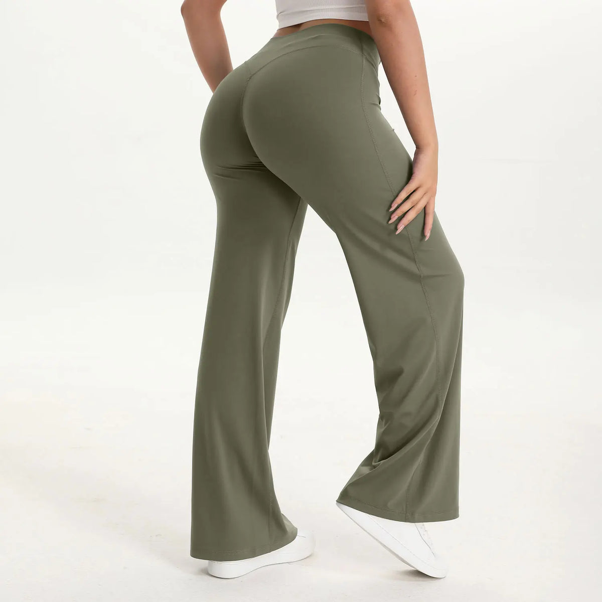 A person wearing olive green NCLAGEN SoftMotion straight leg yoga pants and a light top.