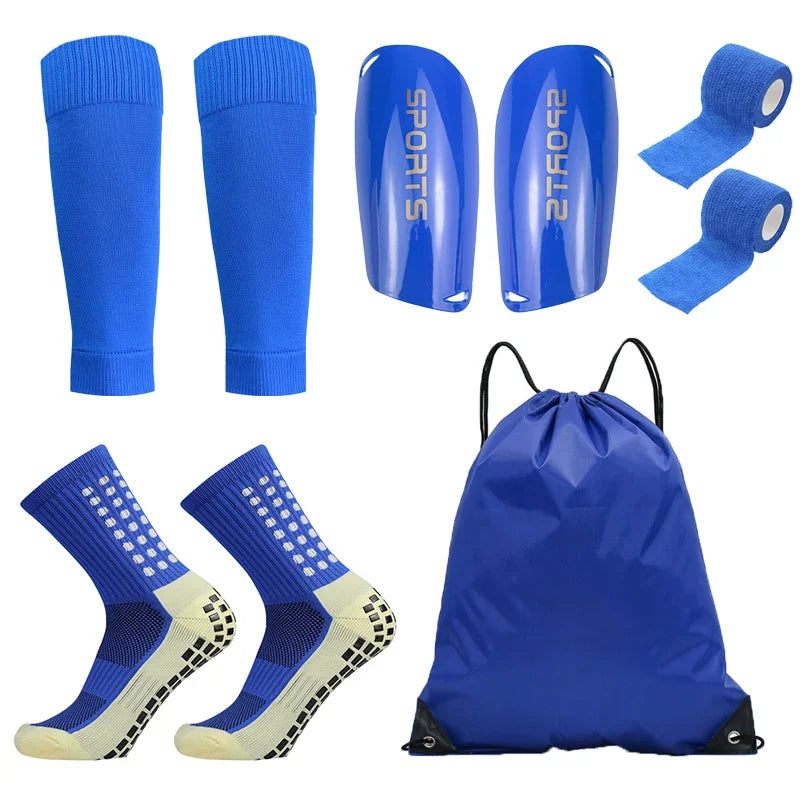 A set of blue football training socks and shin guards displayed individually and packaged in a blue bag.