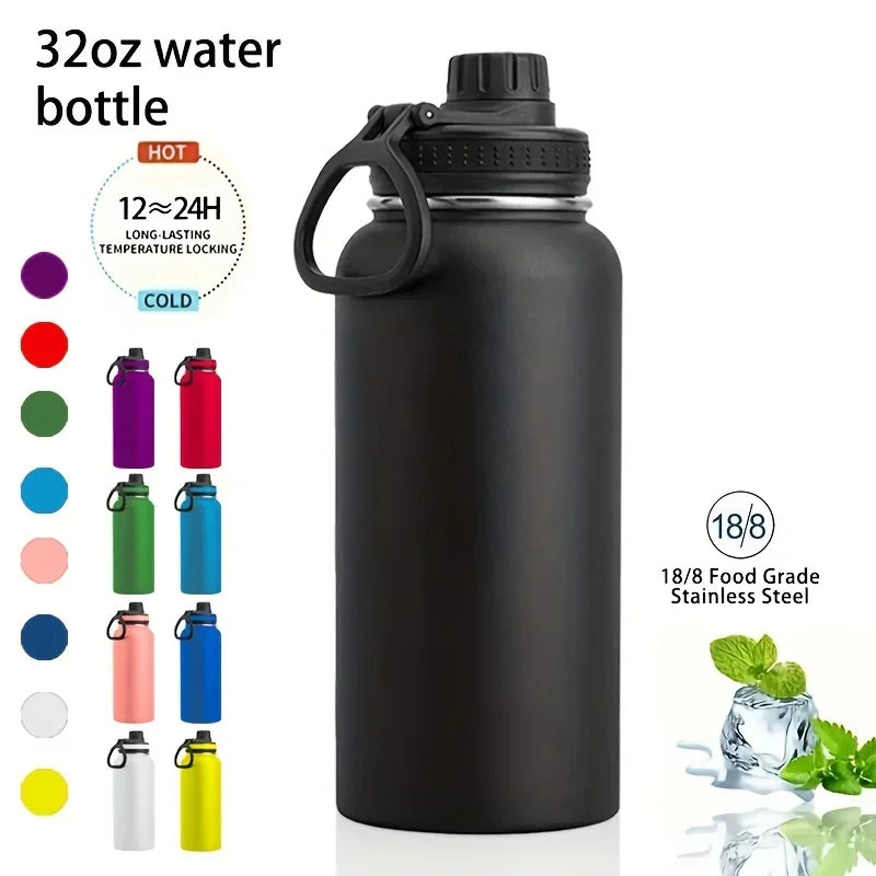A black insulated stainless steel water bottle with a black cap and carrying loop, shown next to various colored bottles.