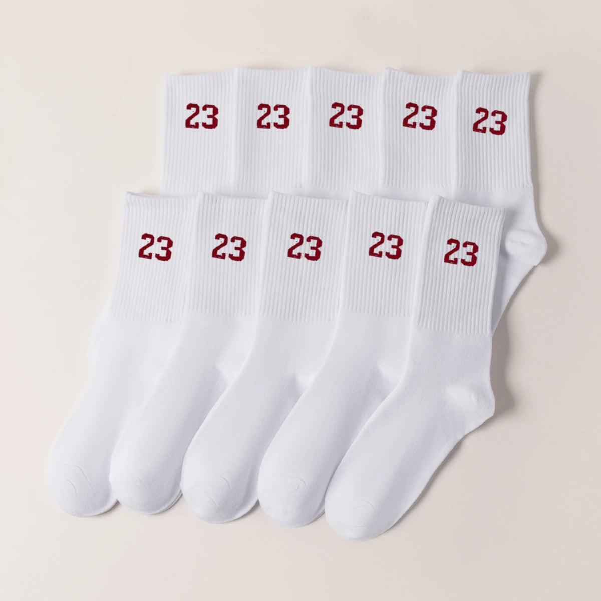A row of twenty-three white men's classic crew socks displayed on a light background.