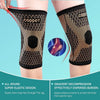 A pair of black copper ion knee support sleeves worn on a leg, demonstrating the elastic design.