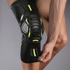 A close-up of a black compression knee brace and support worn on a person's leg.