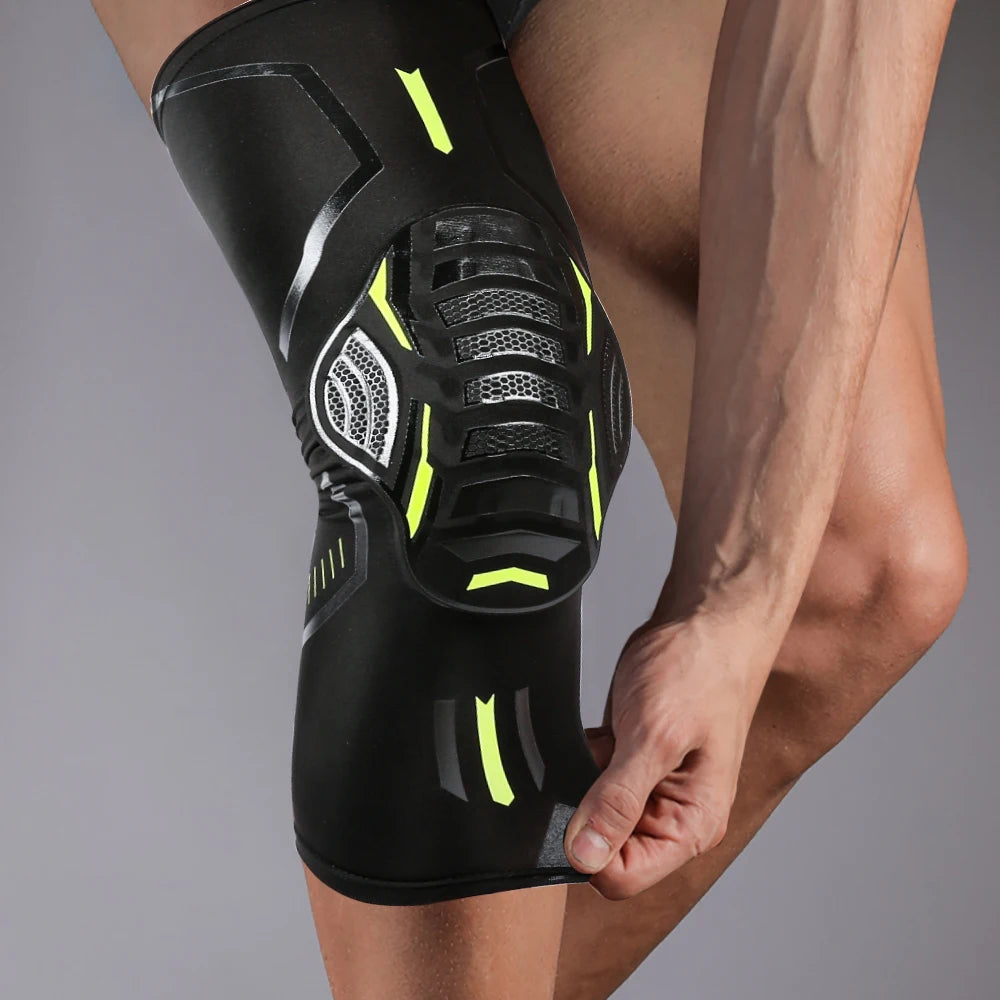 A close-up of a black compression knee brace and support worn on a person's leg.