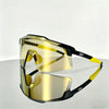 A pair of yellow-tinted sports sunglasses with black frames resting on a smooth surface.