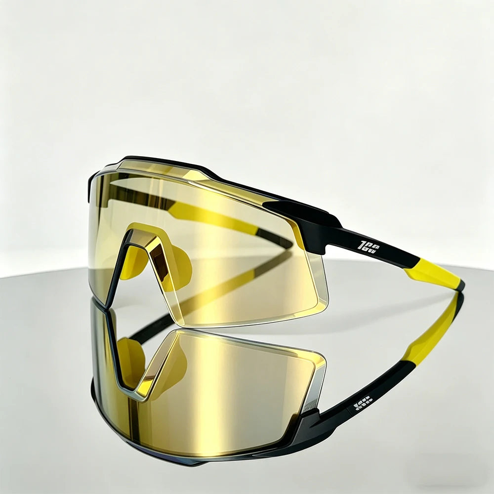 A pair of yellow-tinted sports sunglasses with black frames resting on a smooth surface.