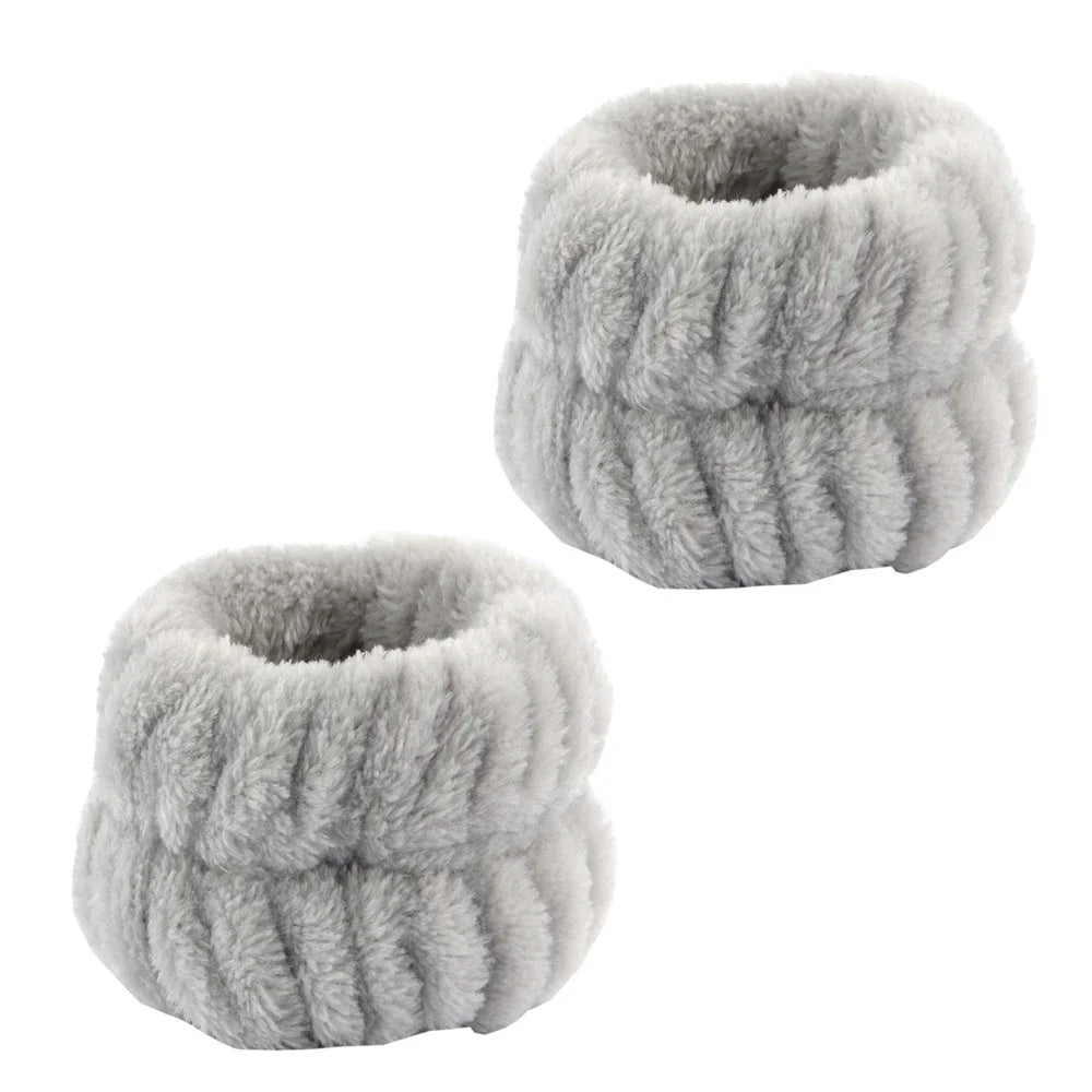 A pair of soft gray microfiber spa headband and wristband set.