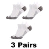 Three pairs of white performance compression sports socks with gray accents shown from the top view.