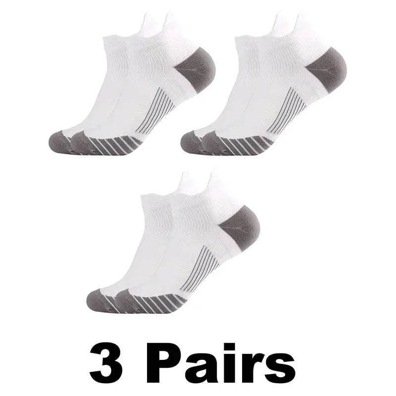 Three pairs of white performance compression sports socks with gray accents shown from the top view.
