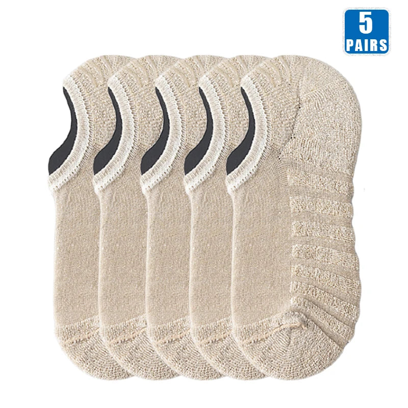 Five pairs of beige men's cotton crew socks stacked together.