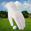 A white men's breathable golf glove is shown on a green lawn next to a golf ball.