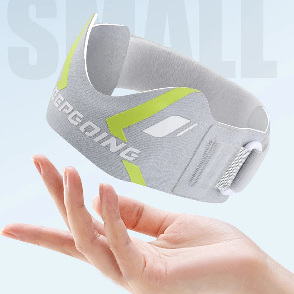 A gray knee strap with neon yellow accents is shown being held by a hand.