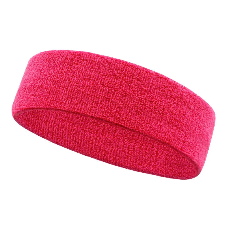 A bright pink moisture-wicking athletic headband shown from the side.