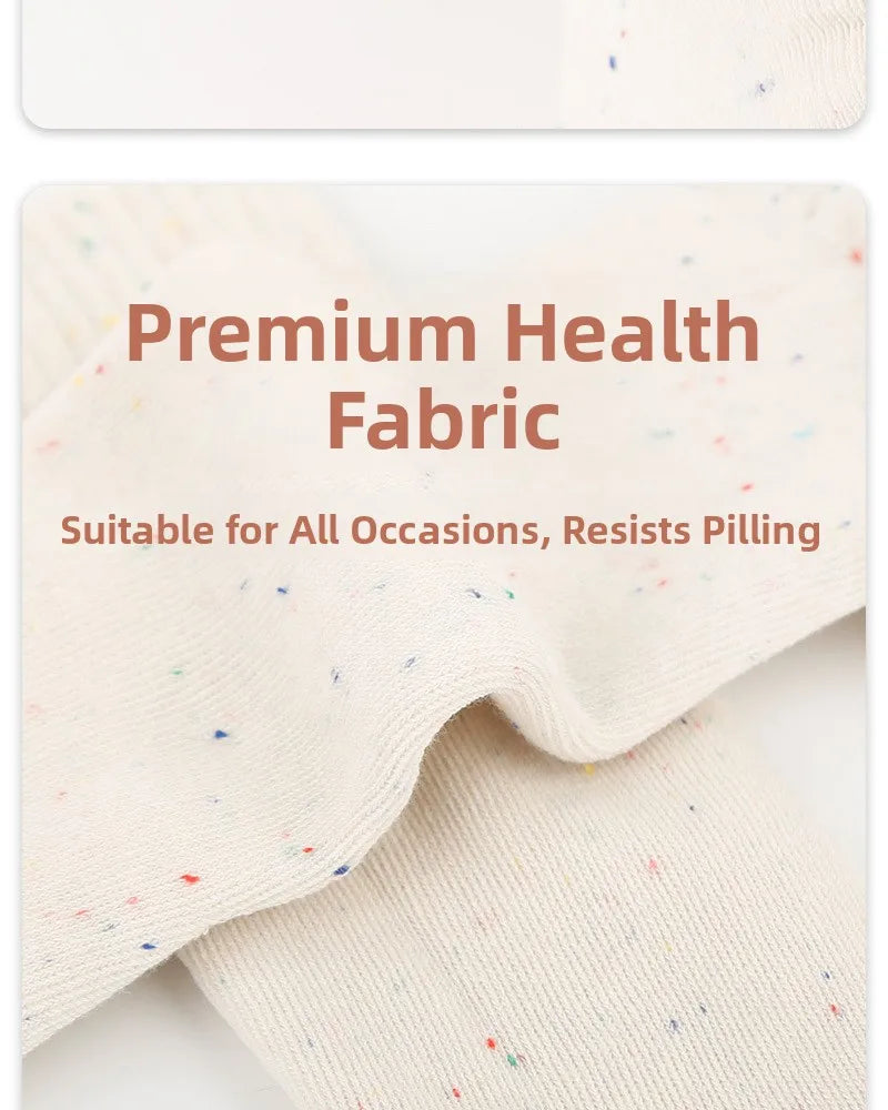 Close-up of cream colored yoga socks with multicolored speckles, showing the premium fabric texture.
