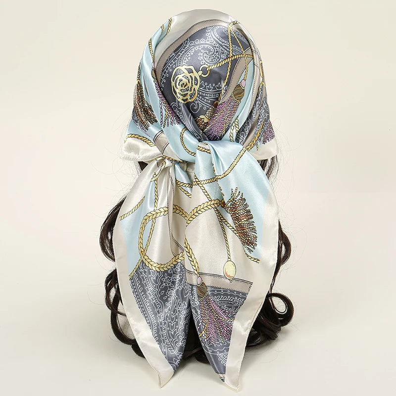 Elegant satin square scarf featuring gold chain details and floral embroidery for hijab and hair