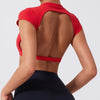 A woman wearing a red women's fitness crop top yoga and gym t-shirt from the back.