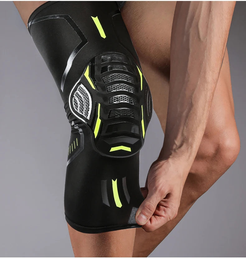 A close-up of a black compression knee brace and support worn on a person's leg.