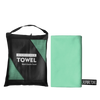 A black microfiber towel bag and a light green microfiber towel are shown side by side.