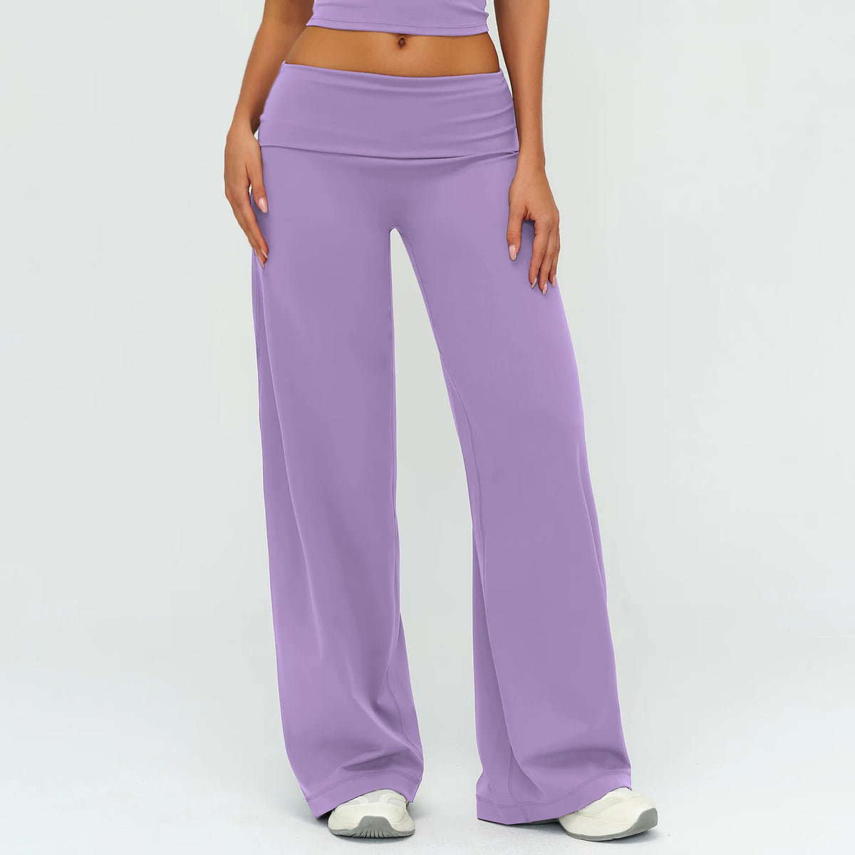 A model is wearing purple flared high-waist yoga and fitness pants.