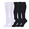 A set of four black and white medical grade compression socks for veins and sports.