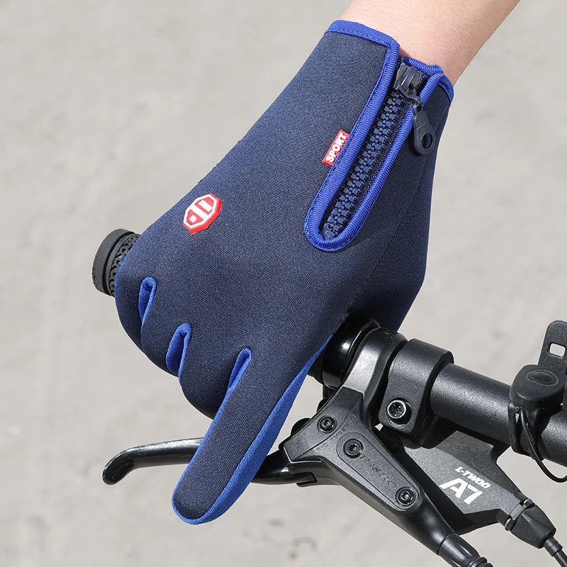 A close-up of a navy blue touchscreen glove with a purple accent, shown on a bicycle handlebar.