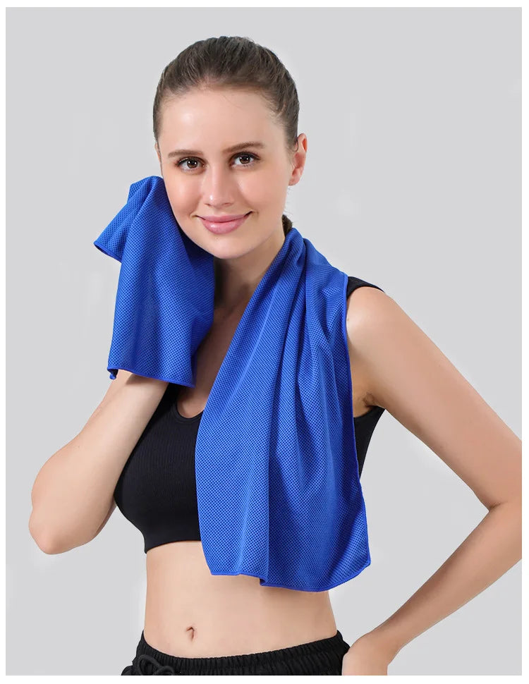 A woman wearing a blue instant cooling towel for sports and fitness.