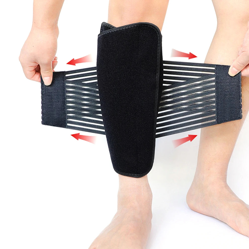 Black adjustable calf compression brace being worn on a person's lower leg.